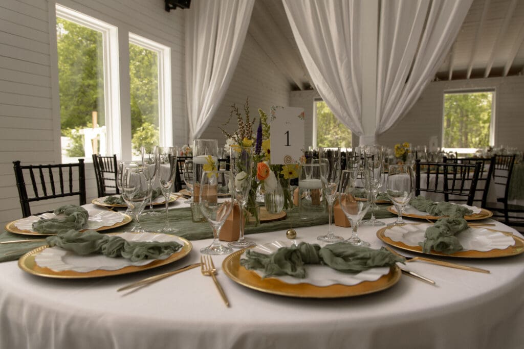 Table display with gold and green accents at blue sky venue in Dallas North Carolina
