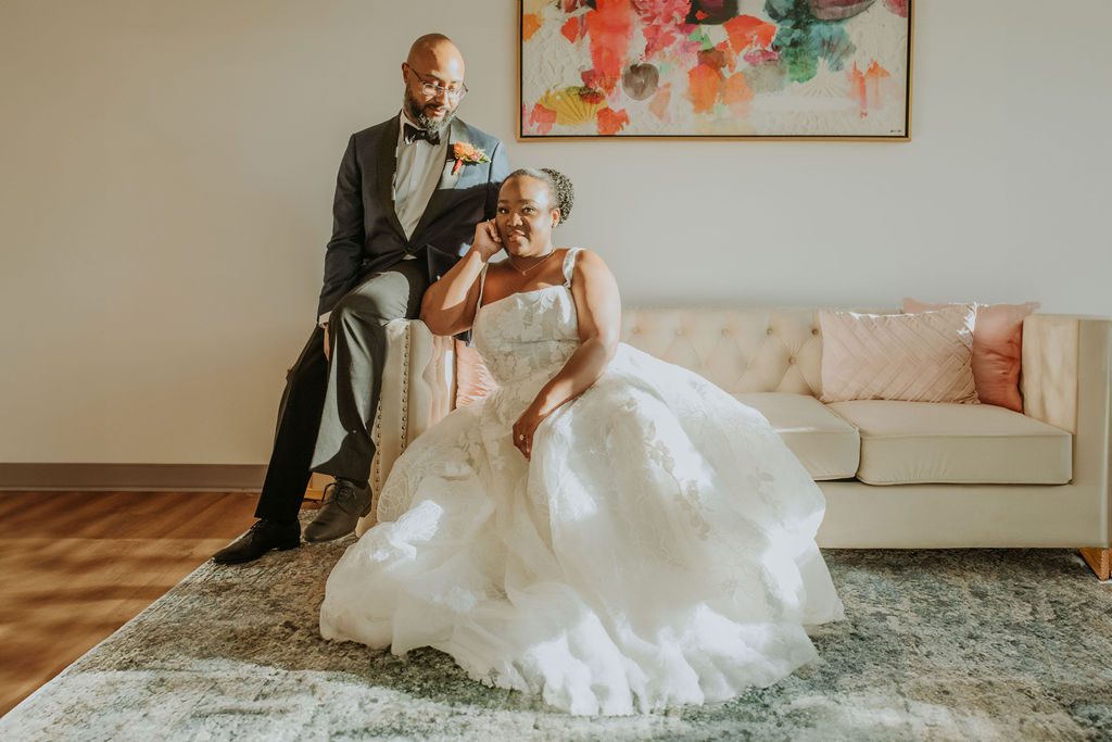 A couple sit on a couch during their wedding photos taken in Morganton North Carolina